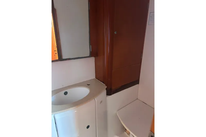Dos Yacht Photos Pics Bathroom interior of 2005 Lagoon 440 yacht with sink and mirror.