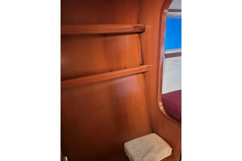 Dos Yacht Photos Pics Interior of 2005 Lagoon 440 yacht with wooden shelves and seating area.