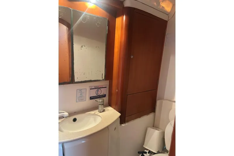 Dos Yacht Photos Pics Bathroom interior of 2005 Lagoon 440 yacht with mirror and sink.