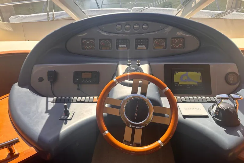 Splendor Yacht Photos Pics Steering wheel and dashboard of a 2007 Azimut 55E yacht with navigation equipment.