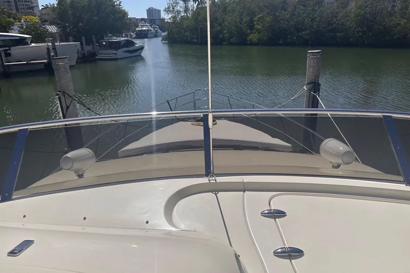 Splendor Yacht Photos Pics 2007 Azimut 55E yacht docked in a serene marina setting.