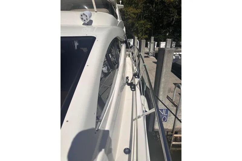 Splendor Yacht Photos Pics 2007 Azimut 55E yacht docked, showcasing sleek white exterior and railing details.