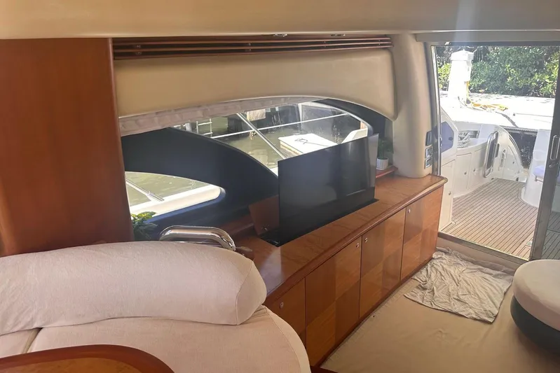 Splendor Yacht Photos Pics Interior of 2007 Azimut 55E yacht with TV, wooden cabinets, and sliding glass door.