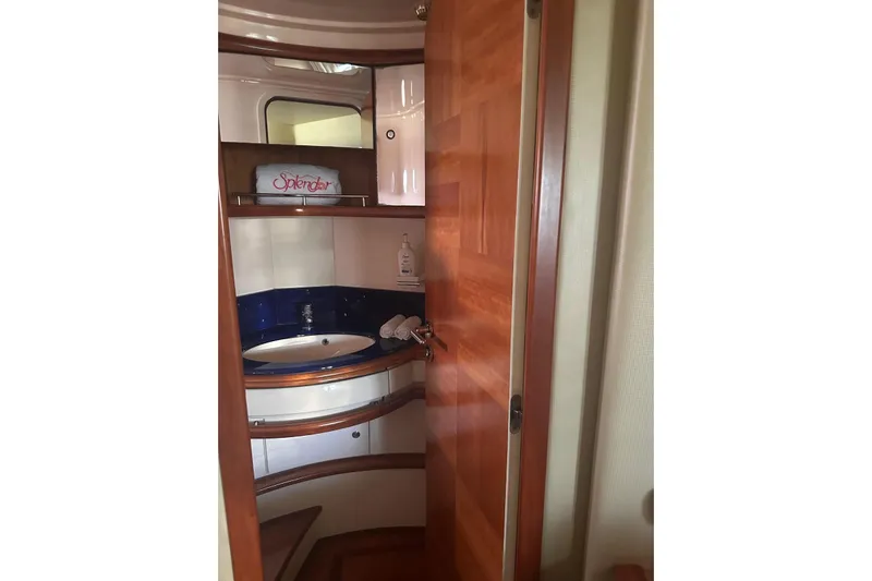 Splendor Yacht Photos Pics Luxurious bathroom interior of 2007 Azimut 55E yacht with wooden accents.