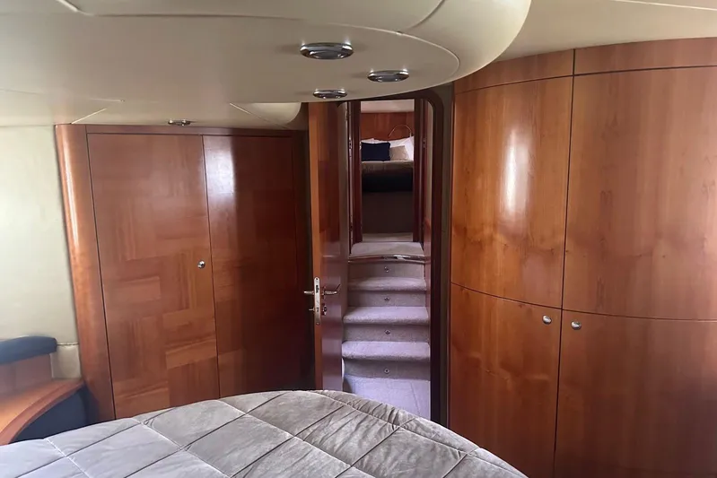 Splendor Yacht Photos Pics Luxurious interior of 2007 Azimut 55E yacht with wooden cabinetry and plush bedding.