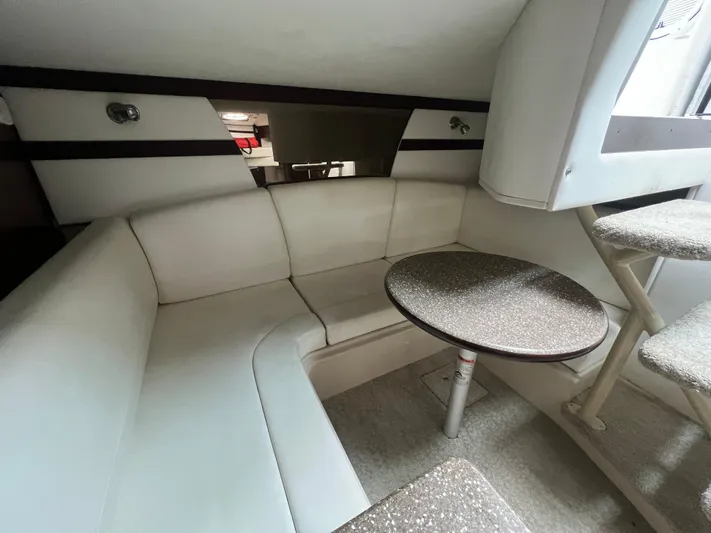  Yacht Photos Pics 2012 Cruisers Yachts 350 Express interior with white seating and round table.