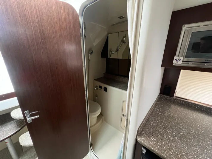  Yacht Photos Pics 2012 Cruisers Yachts 350 Express bathroom interior with modern fixtures and wood accents.