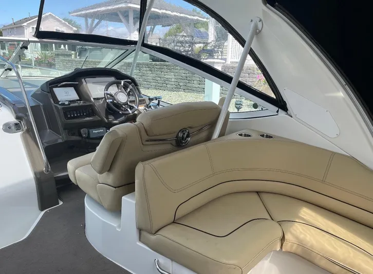  Yacht Photos Pics Interior of 2012 Cruisers Yachts 350 Express with beige seating and modern dashboard.