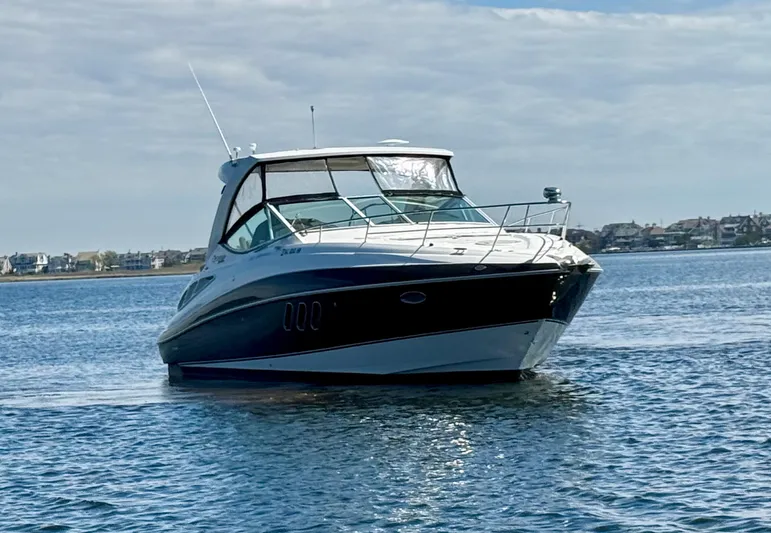  Yacht Photos Pics 2012 Cruisers Yachts 350 Express on calm water under a cloudy sky.