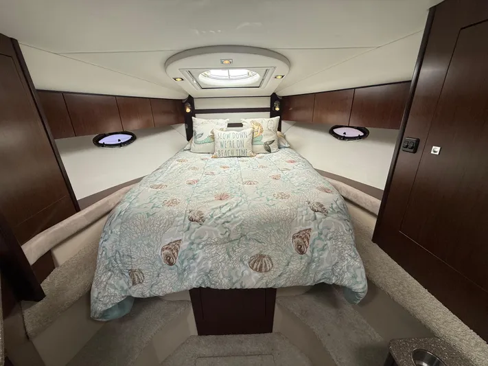  Yacht Photos Pics Luxurious 2012 Cruisers Yachts 350 Express cabin with cozy bedding and elegant wood paneling.