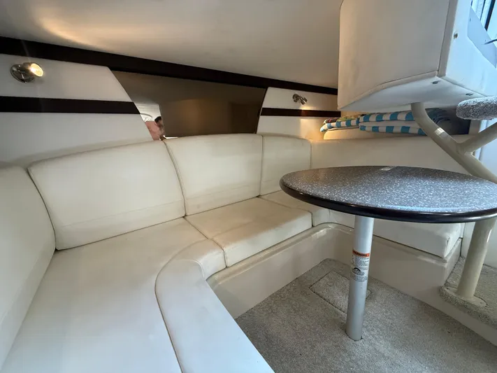  Yacht Photos Pics Interior of 2012 Cruisers Yachts 350 Express with white seating and round table.