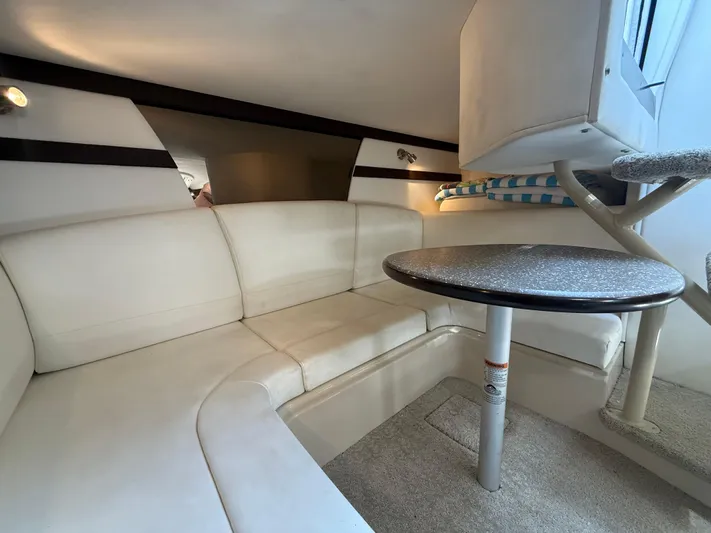  Yacht Photos Pics Interior of 2012 Cruisers Yachts 350 Express with white seating and round table.