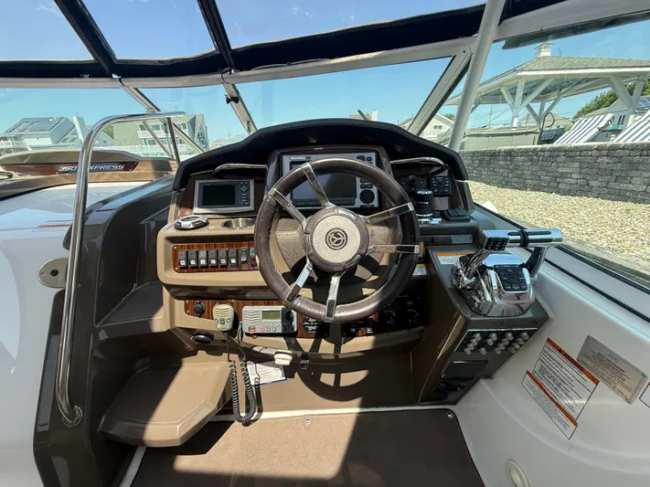  Yacht Photos Pics Cockpit of 2012 Cruisers Yachts 350 Express with steering wheel and control panel.