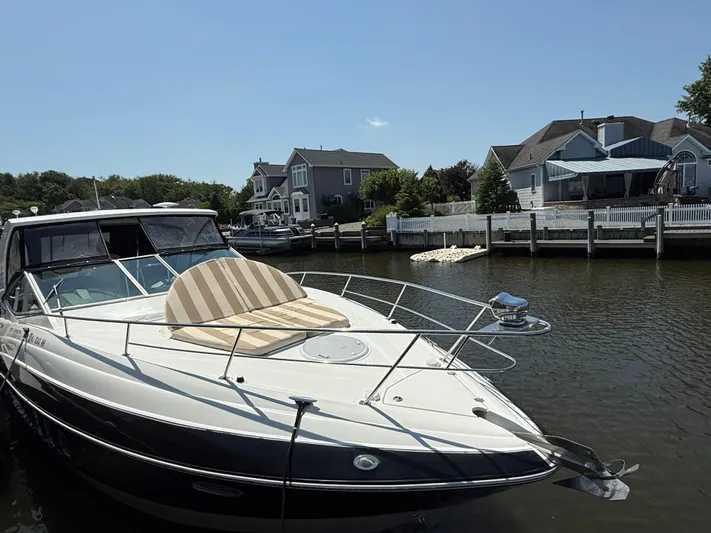  Yacht Photos Pics 2012 Cruisers Yachts 350 Express docked near waterfront homes.