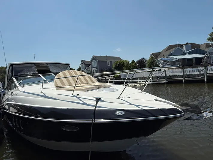  Yacht Photos Pics 2012 Cruisers Yachts 350 Express docked near waterfront homes.