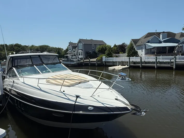  Yacht Photos Pics 2012 Cruisers Yachts 350 Express docked near waterfront homes.