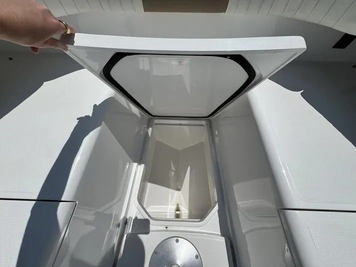  Yacht Photos Pics Open storage compartment on a 2015 Southport 29 FE boat, showcasing spacious interior.
