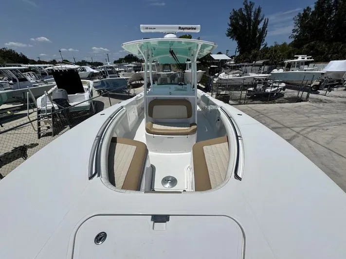  Yacht Photos Pics 2015 Southport 29 FE boat with spacious seating, docked in a marina under clear skies.
