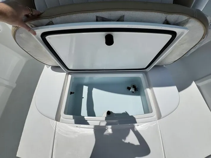  Yacht Photos Pics Open storage compartment on a 2015 Southport 29 FE boat, with shadow reflection.