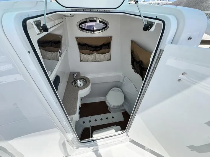  Yacht Photos Pics 2015 Southport 29 FE boat interior with compact bathroom and modern amenities.