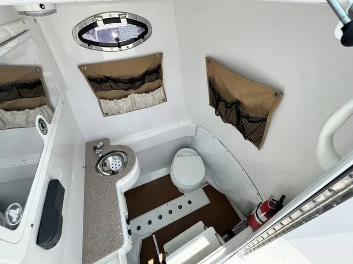  Yacht Photos Pics 2015 Southport 29 FE boat interior with toilet, sink, and storage compartments.