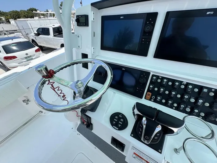  Yacht Photos Pics Control panel of 2015 Southport 29 FE boat with steering wheel and navigation screens.
