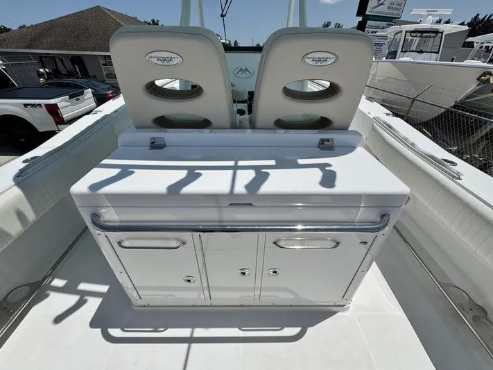  Yacht Photos Pics 2015 Southport 29 FE boat interior with dual seats and storage console.