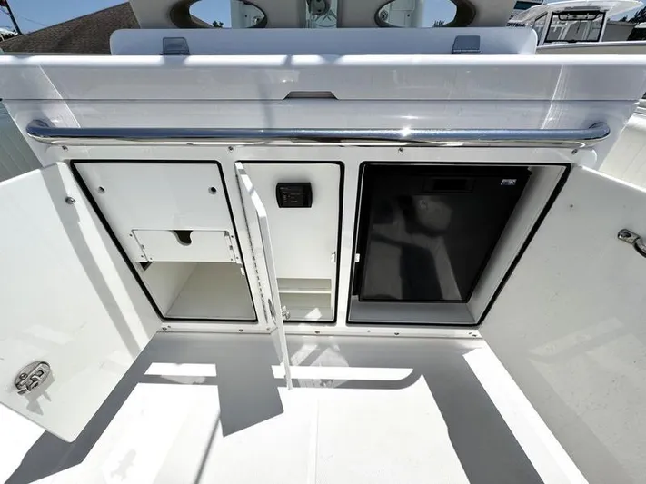  Yacht Photos Pics 2015 Southport 29 FE boat storage compartments with open doors, showcasing interior space.