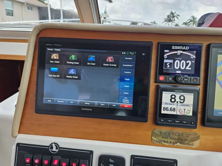 Liberty Call Yacht Photos Pics Home screen on the Garmin MFD, and Simrad Autopilot and Garmin MFD showing depth, water temperature and rudder indicator