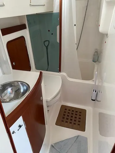 Rogue Fun Yacht Photos Pics 2001 Beneteau Oceanis 44 CC yacht bathroom with sink, shower, and wooden accents.