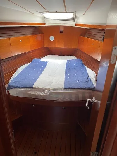 Rogue Fun Yacht Photos Pics Cozy cabin interior of 2001 Beneteau Oceanis 44 CC sailboat with wooden finish.
