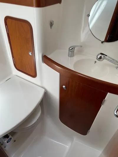 Rogue Fun Yacht Photos Pics 2001 Beneteau Oceanis 44 CC bathroom with wooden cabinetry and modern fixtures.