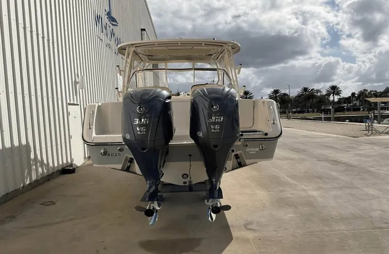  Yacht Photos Pics 2022 Grady-White Freedom 307 boat with dual outboard engines, docked outdoors.