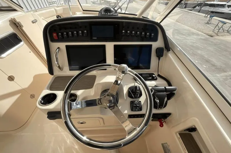  Yacht Photos Pics 2022 Grady-White Freedom 307 boat dashboard with steering wheel and control panels.
