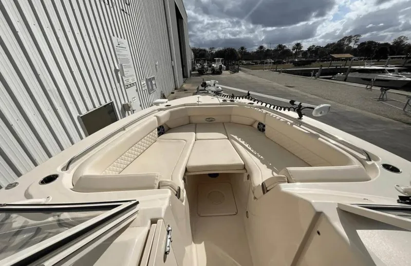  Yacht Photos Pics 2022 Grady-White Freedom 307 boat, spacious seating, docked near a marina under cloudy skies.