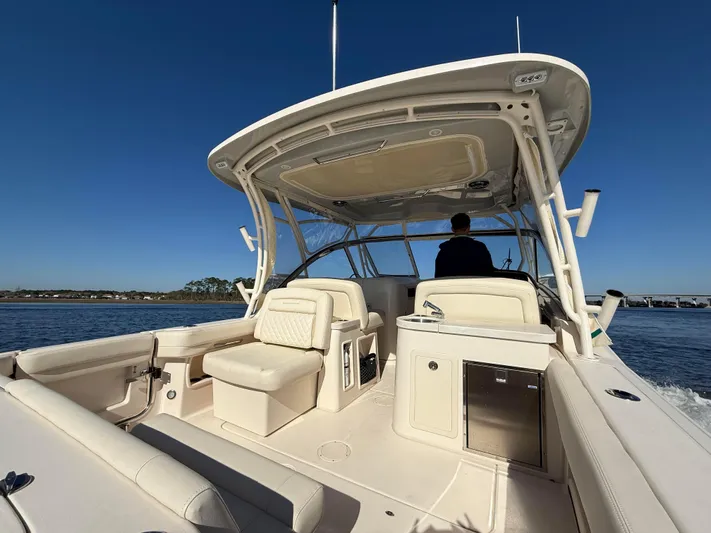  Yacht Photos Pics 2022 Grady-White Freedom 307 boat on water, featuring spacious seating and sleek design.