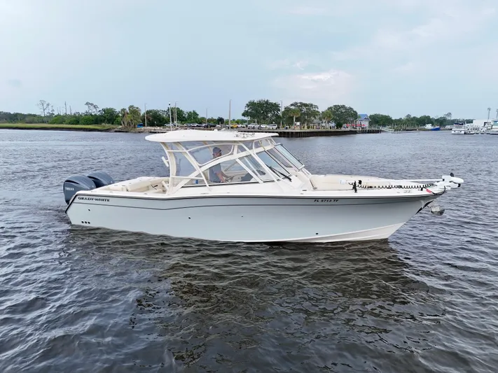  Yacht Photos Pics 2022 Grady-White Freedom 307 boat on calm water, side view.