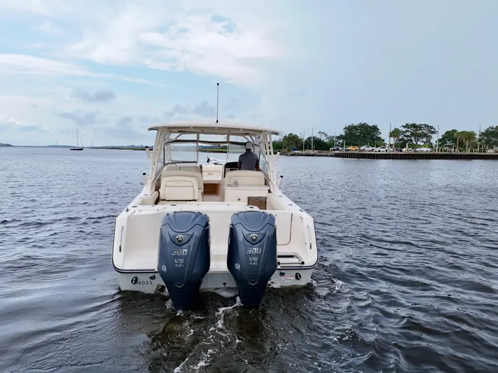 Yacht Photos Pics 2022 Grady-White Freedom 307 boat on water, rear view with dual engines.