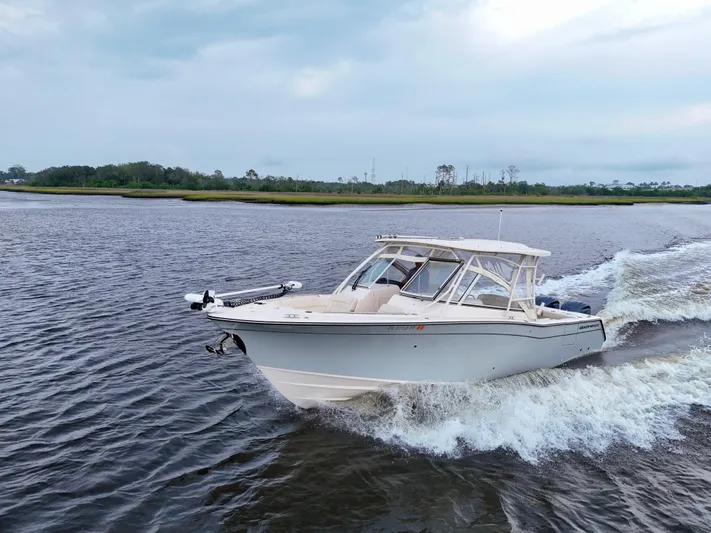  Yacht Photos Pics 2022 Grady-White Freedom 307 cruising on a scenic waterway.