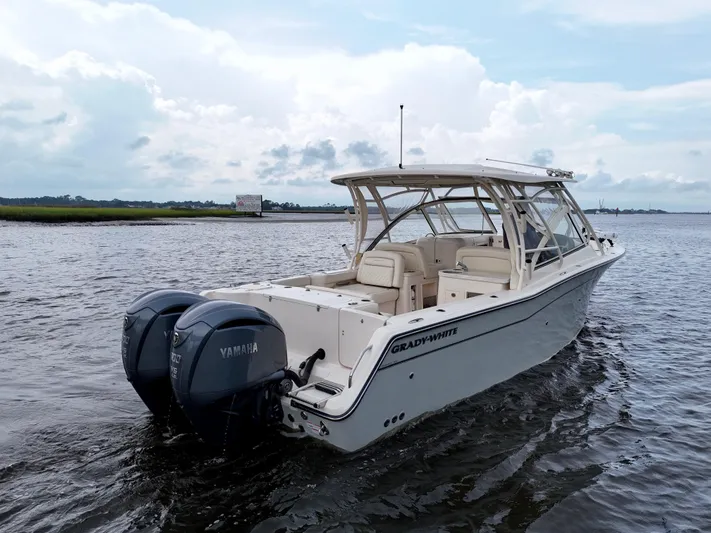  Yacht Photos Pics 2022 Grady-White Freedom 307 boat with Yamaha engines on calm water.