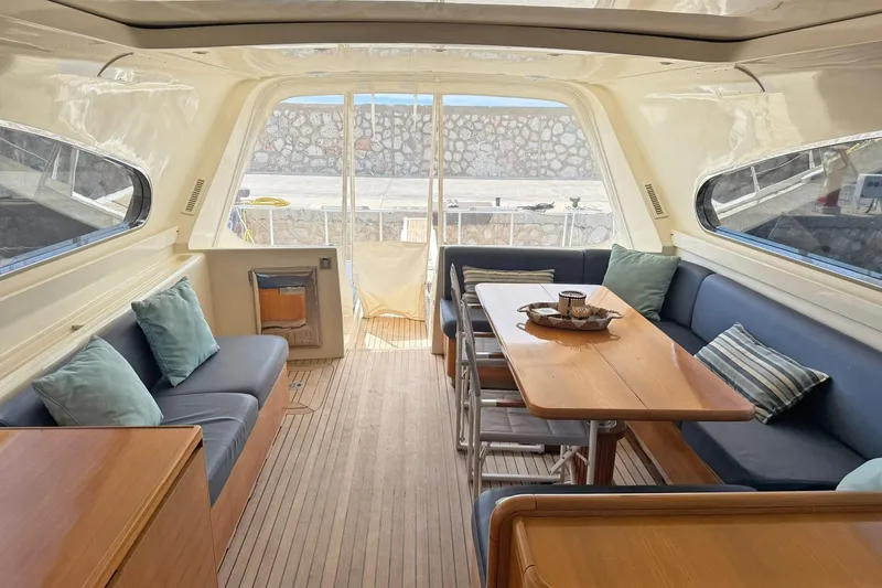 Slim Yacht Photos Pics Interior of 2006 Arno Leopard 23 HT yacht with elegant seating and wooden table.