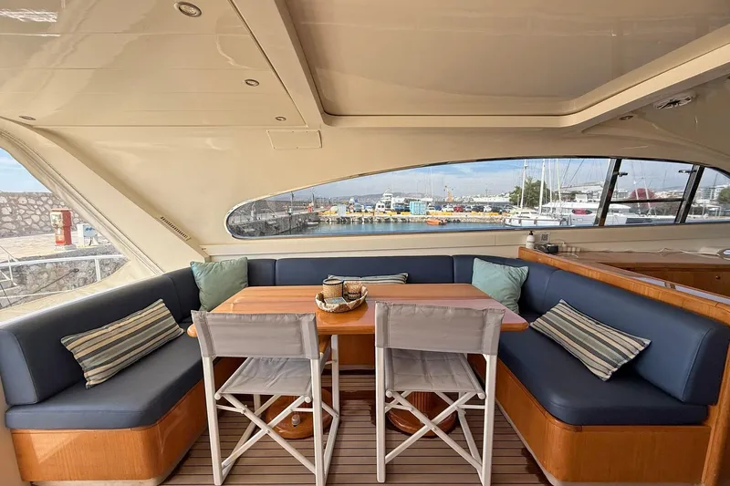 Slim Yacht Photos Pics Luxurious interior of 2006 Arno Leopard 23 HT yacht with elegant seating and harbor view.