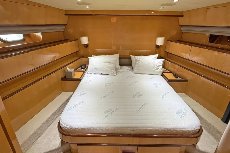 Slim Yacht Photos Pics Luxurious cabin interior of 2006 Arno Leopard 23 HT yacht with cozy bed and wooden finish.