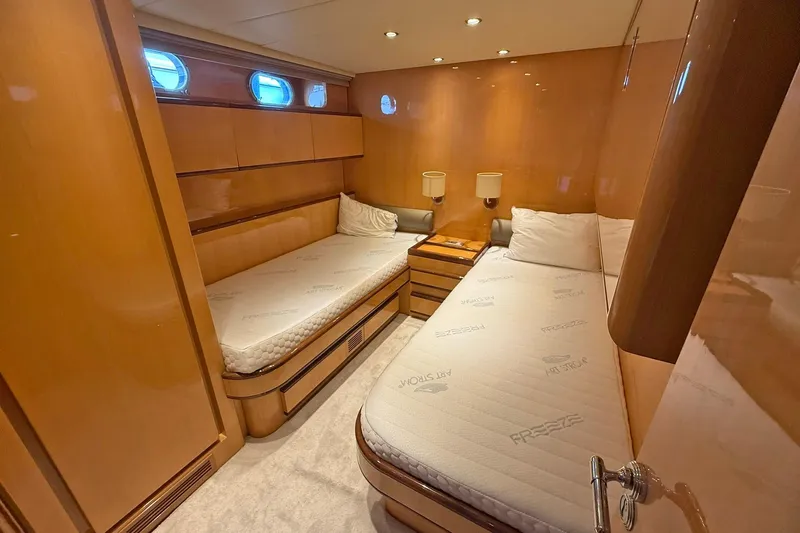 Slim Yacht Photos Pics Luxurious cabin interior of 2006 Arno Leopard 23 HT yacht with twin beds and wooden finish.