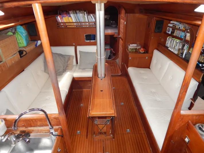  Yacht Photos Pics Interior of 1983 Nautor Swan 42 yacht with wooden finish and white seating.
