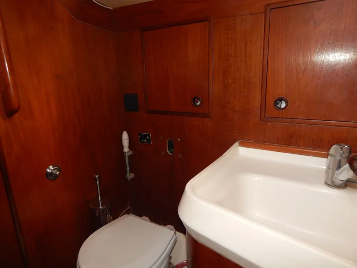  Yacht Photos Pics Nautor Swan 42 yacht bathroom, 1983 model, featuring wooden cabinetry and a compact sink.