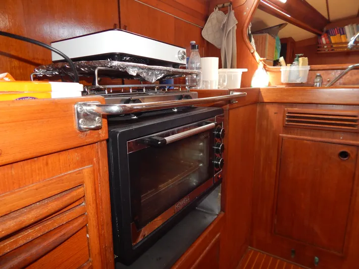  Yacht Photos Pics Wooden interior kitchen of 1983 Nautor Swan 42 yacht with oven and stove.