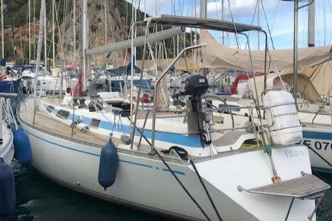  Yacht Photos Pics 1983 Nautor Swan 42 sailboat docked in a marina, featuring classic design and blue accents.