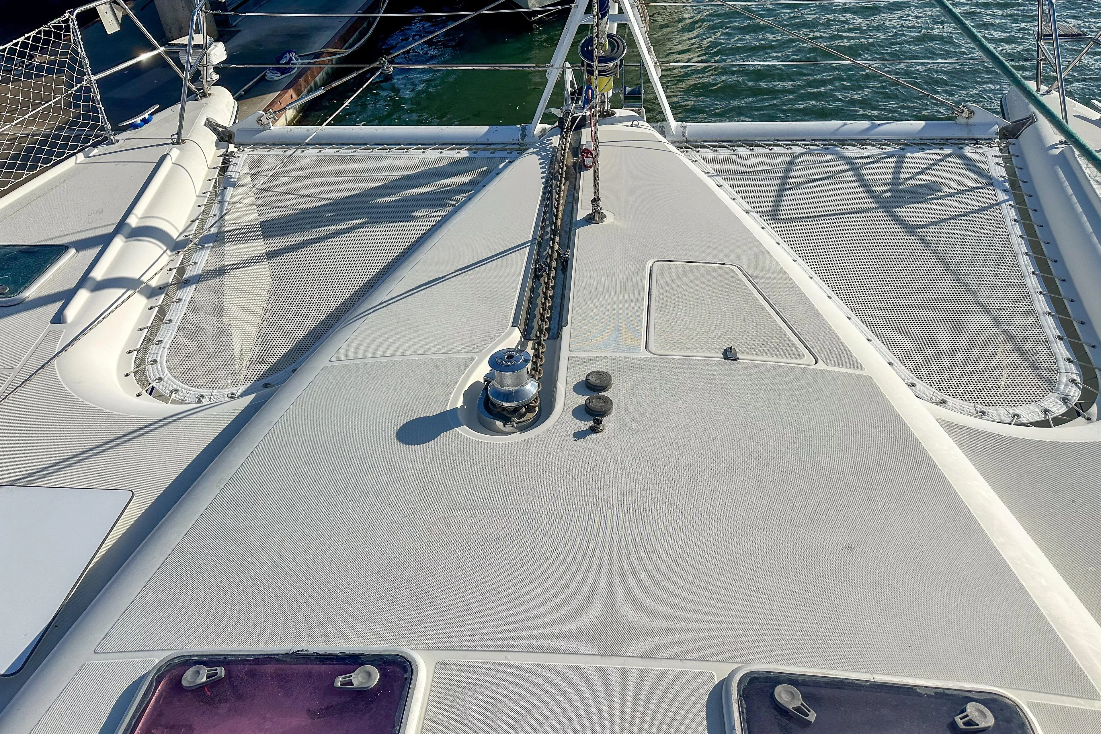 Deck view of a 2001 Privilege 435 catamaran with netting and winch.