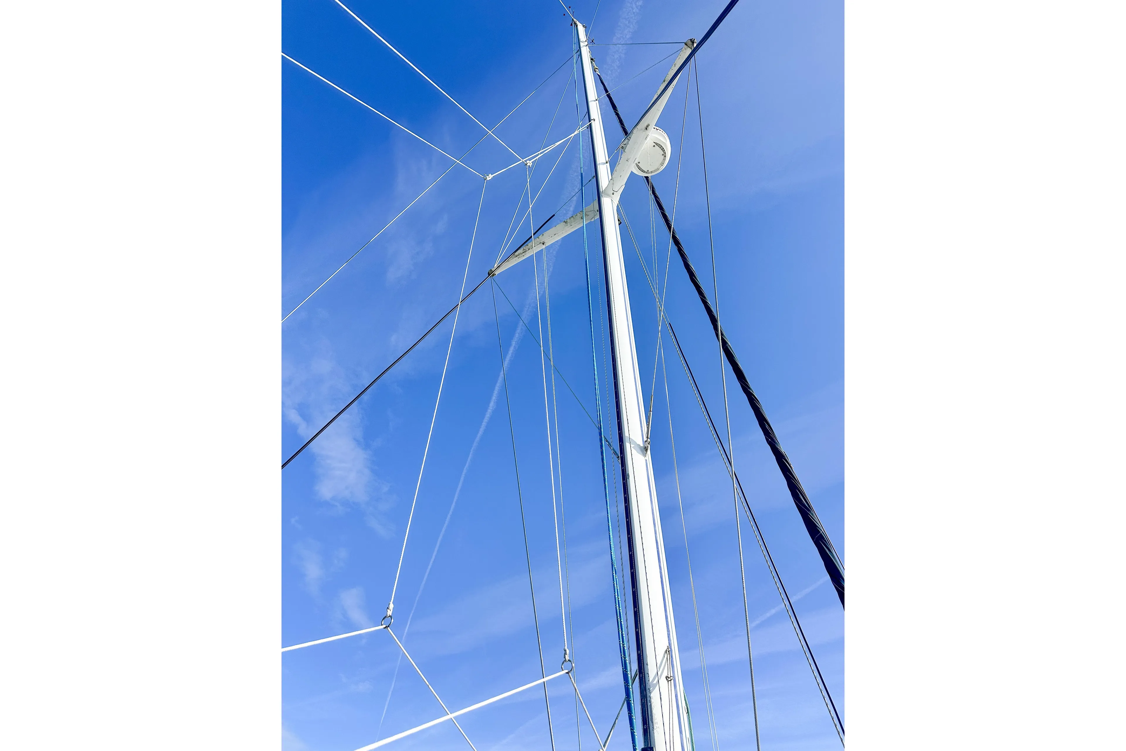 Sailboat mast and rigging against a clear blue sky, Privilege 435, 2001 model.